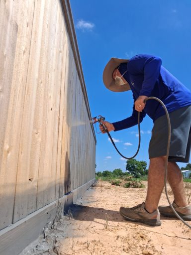 Commercial cedar fence staining project in Hockley TX by LRS Fencing & Gates