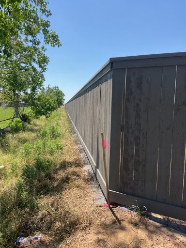 Commercial cedar fence staining project in Hockley TX by LRS Fencing & Gates