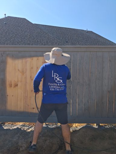 Commercial cedar fence staining project in Hockley TX by LRS Fencing & Gates
