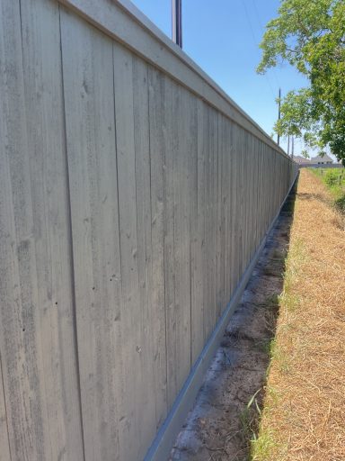 Commercial cedar fence staining project in Hockley TX by LRS Fencing & Gates